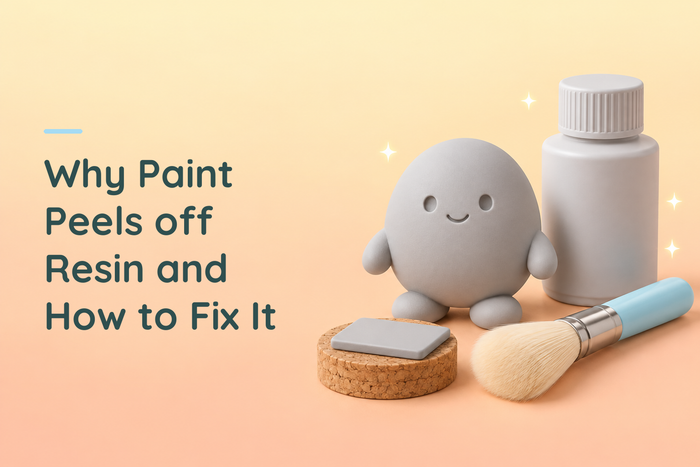 Grey resin character beside a test tile, primer bottle and soft brush