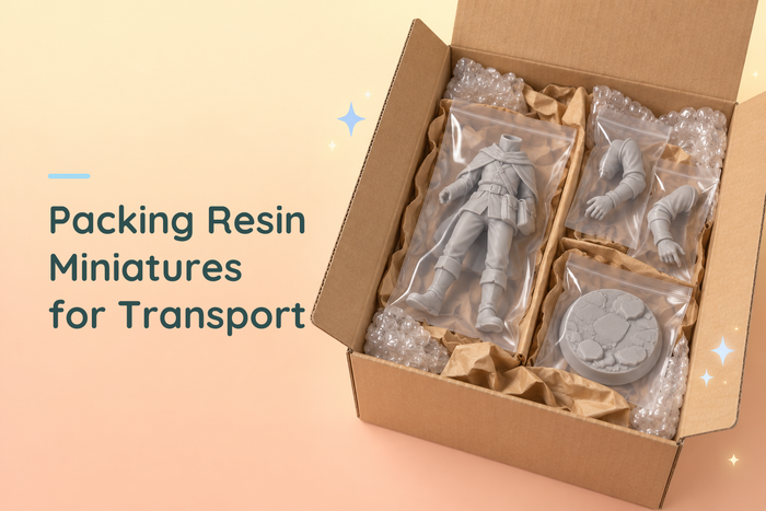 Individually bagged grey resin kit parts in a cardboard box with paper and bubble wrap