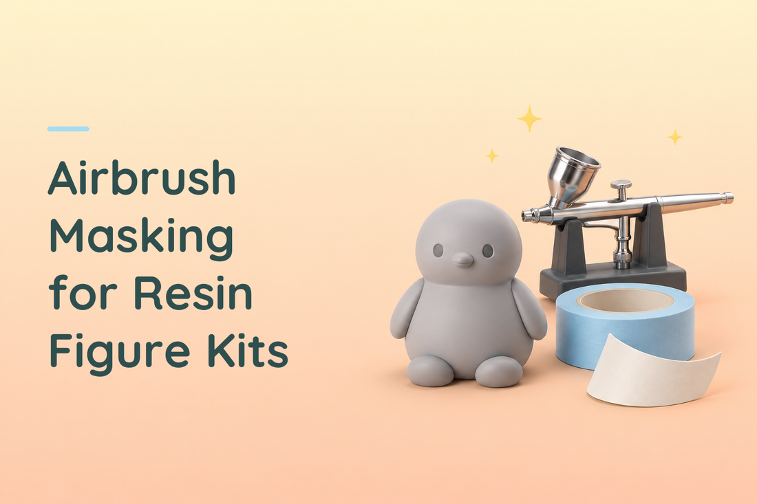 Grey resin bird figure beside an airbrush and blue masking tape