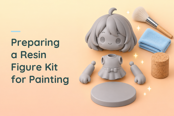 Separate grey resin character parts beside a soft brush, blue cloth and cork