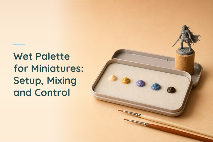 Wet palette for miniatures beside an original grey resin figure with acrylic paint and two detail brushes