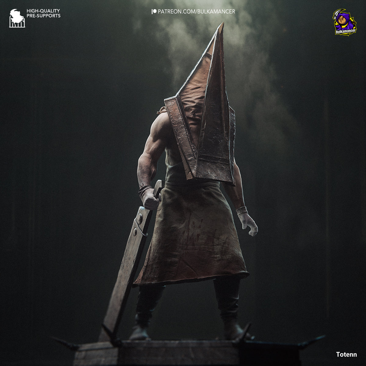 Pyramid Head resin figure standing in profile, holding large blade, wearing brown leather apron and pyramid helmet, detailed paint finish on dark base.