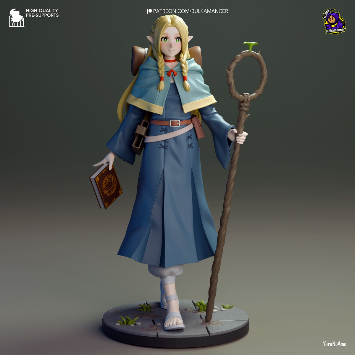 Marcille resin figure from Delicious in Dungeon, front-facing pose holding staff and spellbook, painted with blue robes and blonde braids, standing on scenic base.