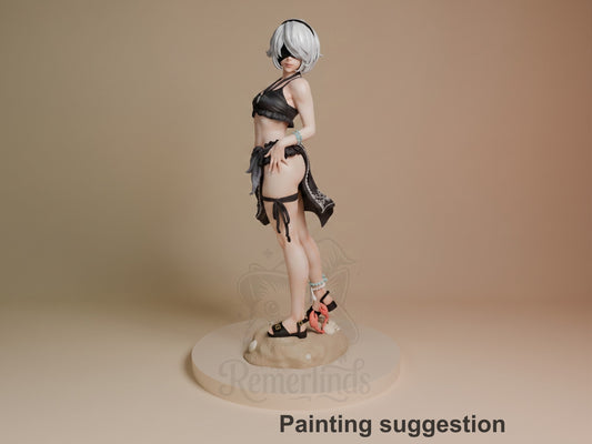 2B resin figure in black swimsuit, posed sideways on sand base, white hair covering eyes, blue bracelets, holding weapon, painted suggestion.