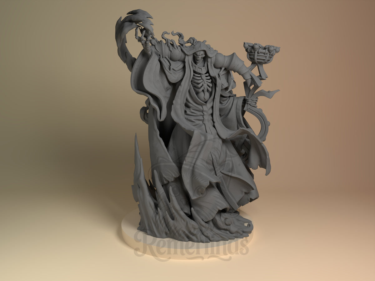 Bone Sovereign Sorcerous Dominion 3D printed resin figure by Nomnom, unpainted front view. The miniature depicts a skeletal figure in a powerful, commanding pose, with detailed tattered robes flowing dynamically around it. The left hand holds an intricately designed staff, while the right is raised as if casting a spell or exerting control. The base complements the figure's menacing presence with jagged, flame-like elements, emphasizing its sorcerous and ominous nature.