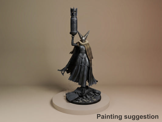 Artillery Witch resin figure from Trench Crusade, painted black with gold trim, holding cannon aloft, horned helm, flowing cape, rocky base, displayed on neutral platform.
