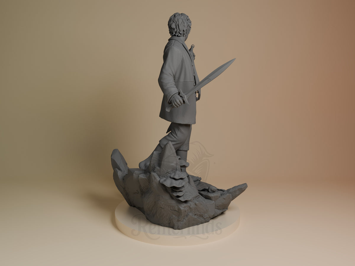 Back view shows unpainted Bilbo Baggins from Lord of the Rings, a resin figure holding a sword on a sculpted creature base.