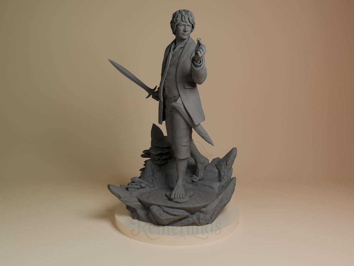 Unpainted Bilbo Baggins resin figure from Lord of the Rings holds sword and ring on sculpted base.