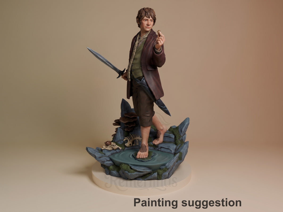 Painted resin figure of Bilbo Baggins from Lord of the Rings stands with sword and ring on a rocky water base.
