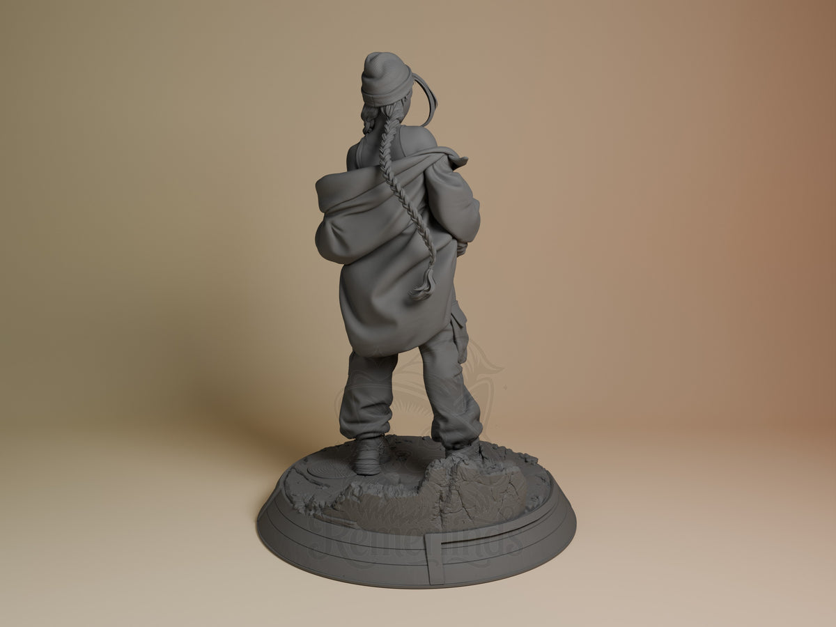 Cammy resin figure shown from behind, wearing hooded jacket with rope detail, standing on textured base, unpainted gray prototype.