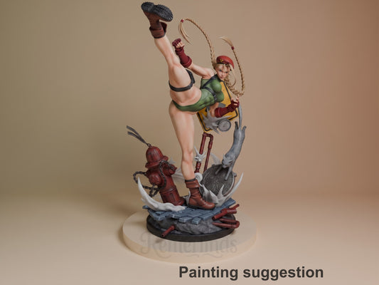 Cammy resin figure painted in green and red outfit, mid-kick pose with rope, dynamic base with fire hydrant and debris details.