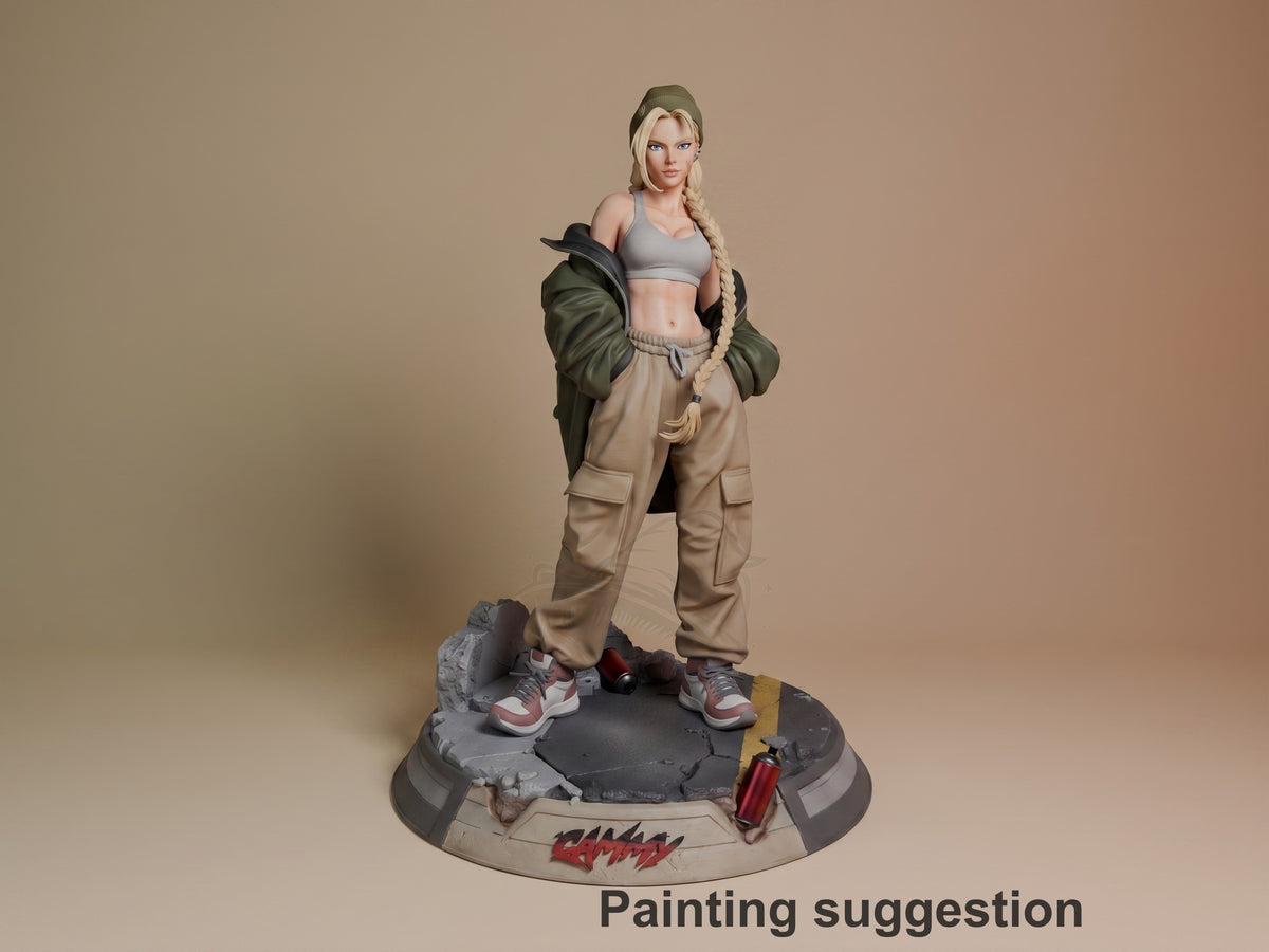 Cammy resin figure from Street Fighter in painted form, standing on tactical base with braided hair, crop top, and cargo pants, shown from front angle.