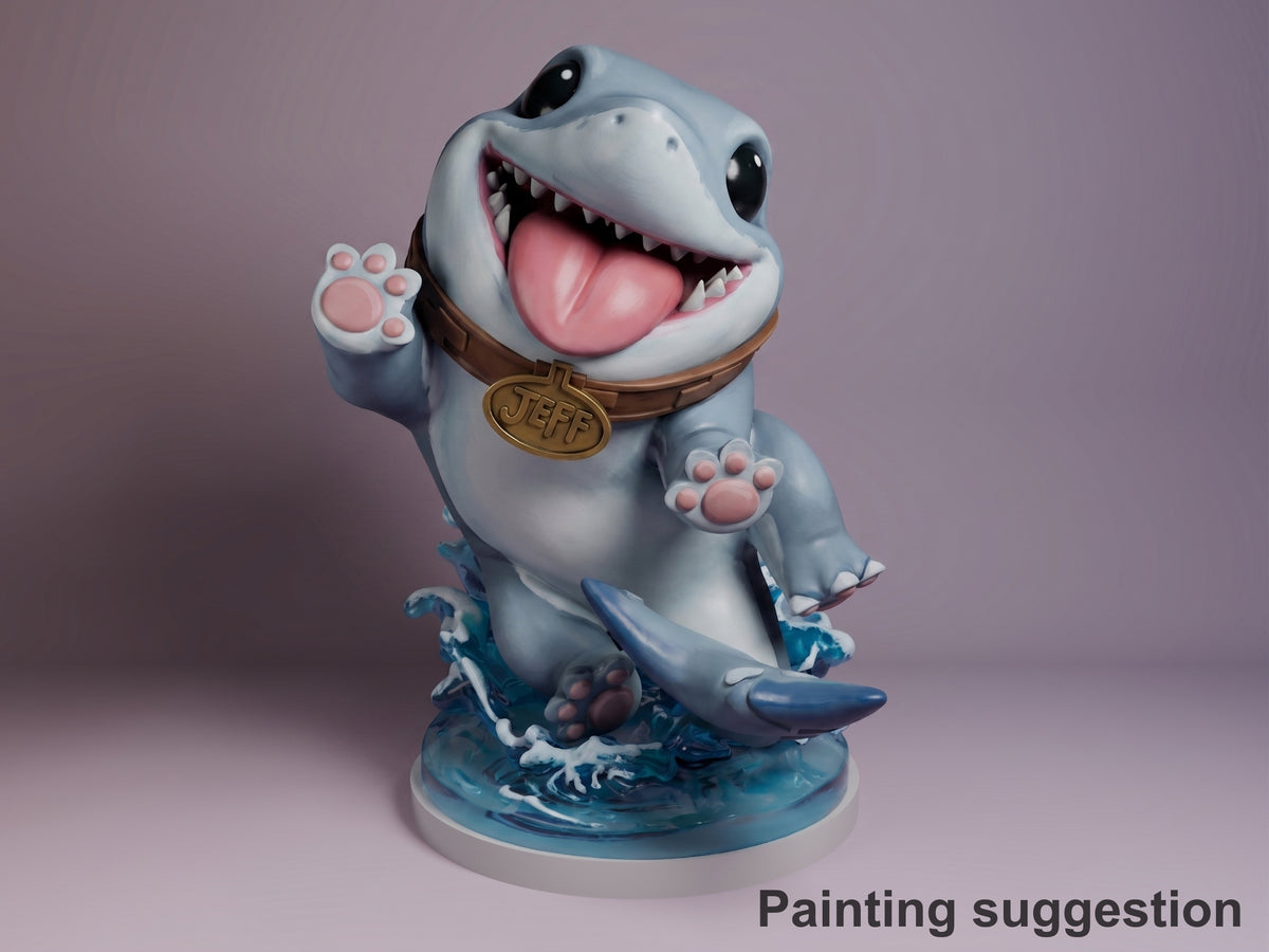 Painted resin Chibi Shark Pal figure from Super Rivals, grinning with raised paw, wearing brown collar with JEFF medal, on blue wave base against purple background.