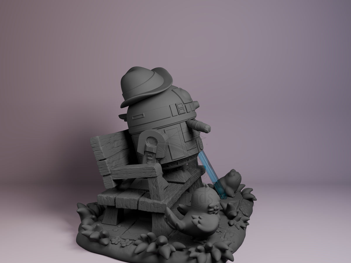 R2D2 resin Chibi figure from Star Wars, seated on wooden crate with blue lightsaber, unpainted gray finish, right side view against purple background.