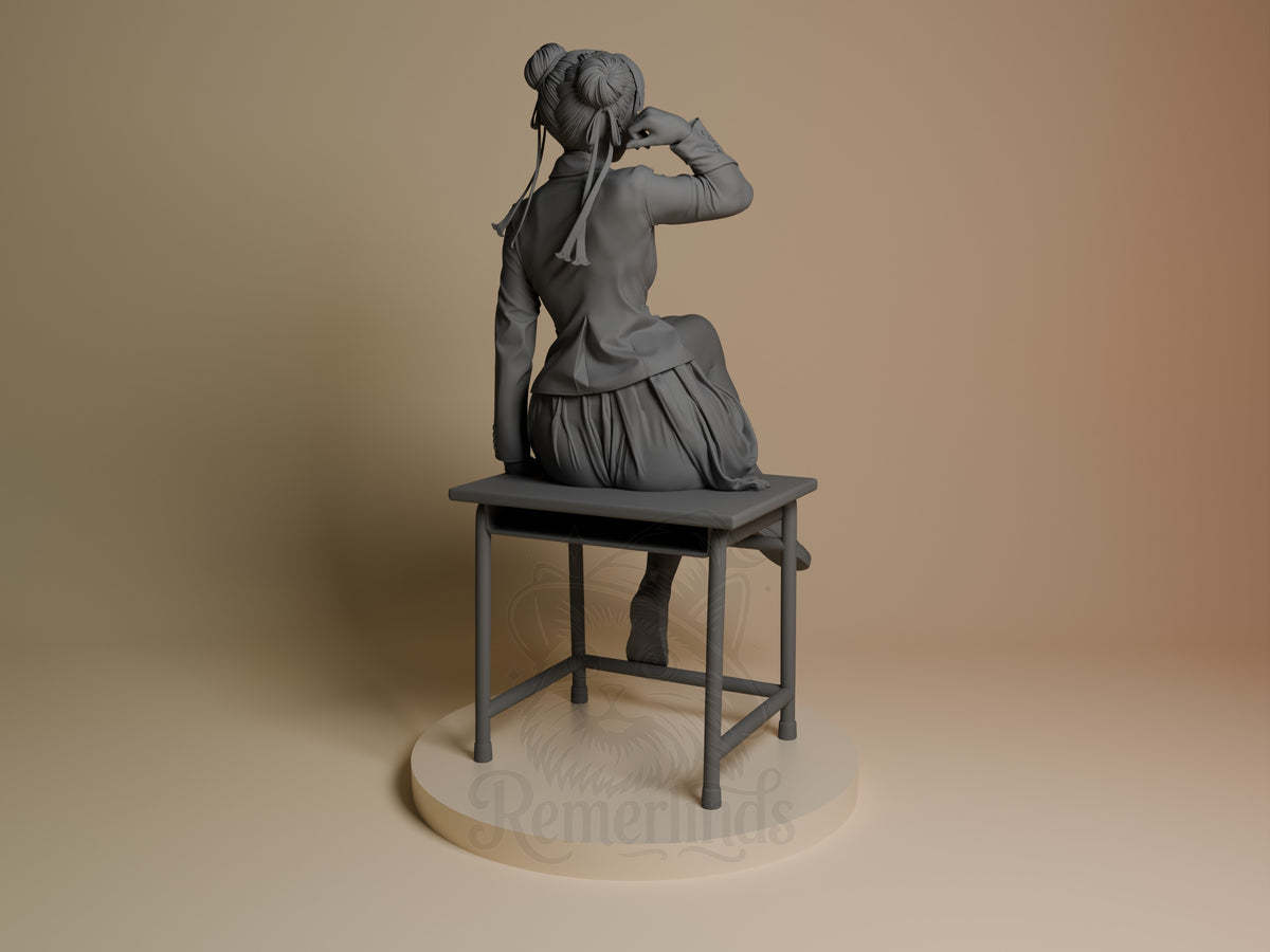 Chun-Li resin figure from Street Fighter shown from behind, seated on a chair with hair in buns, unpainted gray finish, on a round base.