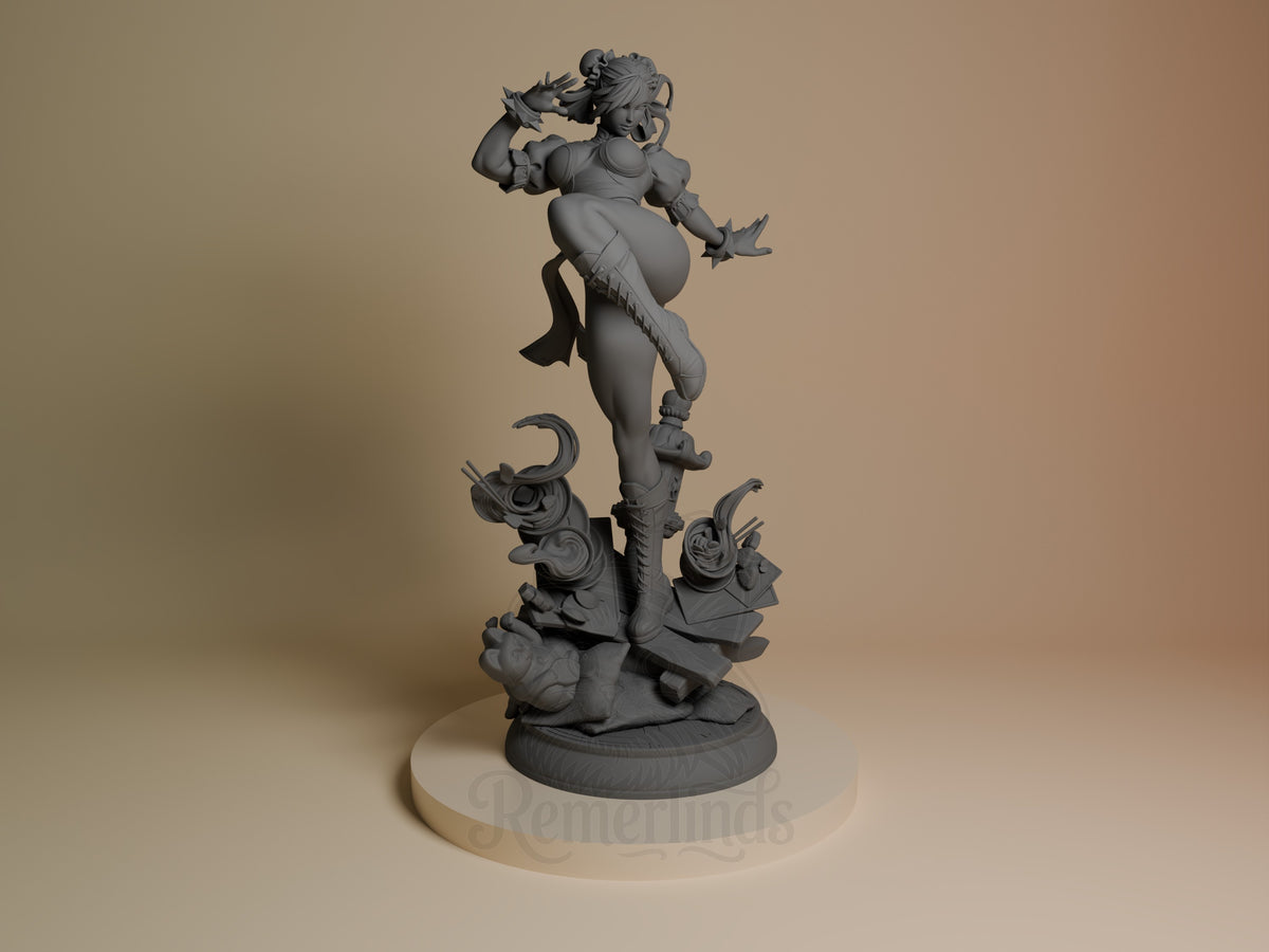 Chun-Li resin figure in unpainted gray, posed dynamically on decorative base with demon heads, front view showing detailed sculpting and flowing hair.