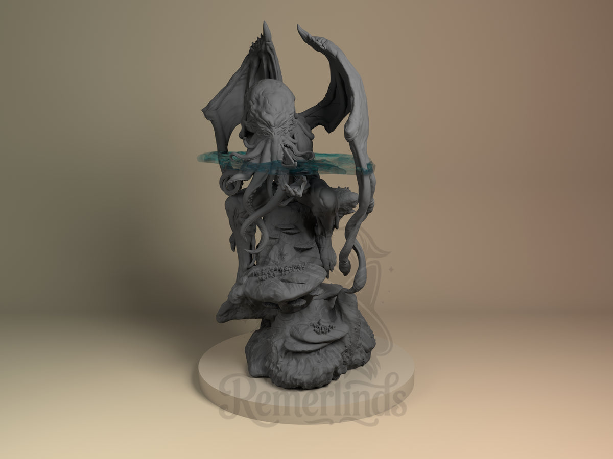 Cthulhu Mythos 3D printed resin figure by Nomnom, unpainted front view. The figure depicts Cthulhu standing with a slightly forward and menacing posture. It holds a long curved staff or tentacle-like object in one hand, featuring large bat-like wings extending from its back and multiple facial tentacles. The detailed base resembles an underwater rocky or coral terrain, complementing the mythos theme of the character.