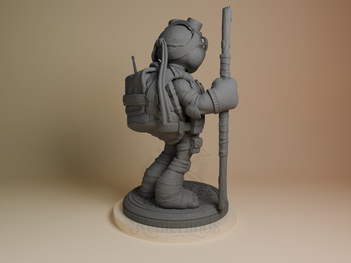ByteStaff from Shellguard resin figure shown from behind, unpainted gray, holding staff upright with backpack and helmet visible on circular base.