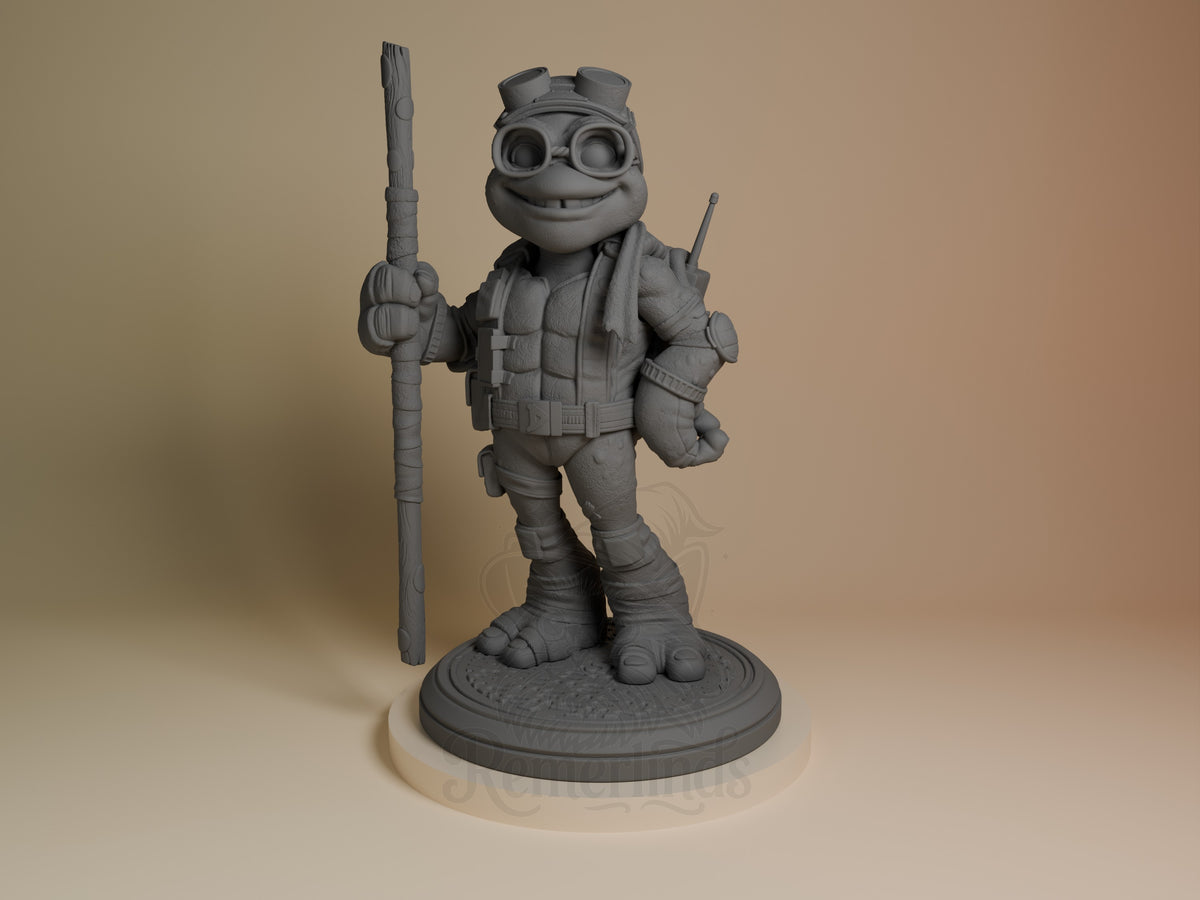 ByteStaff from Shellguard resin figure shown from front, smiling turtle character in tactical gear holding staff, unpainted gray resin on circular base.