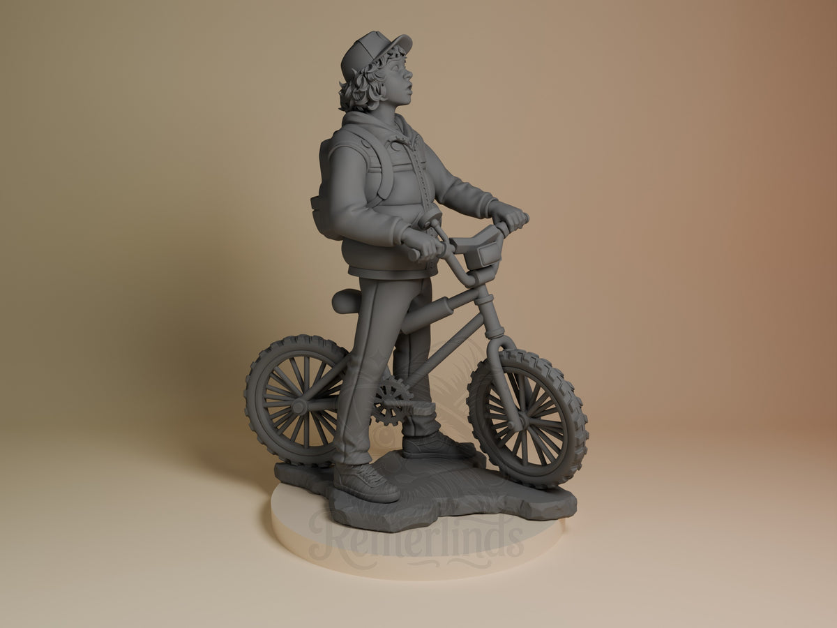 Dustin from Stranger Things is an unpainted resin figure shown in profile on a bicycle and sculpted base.