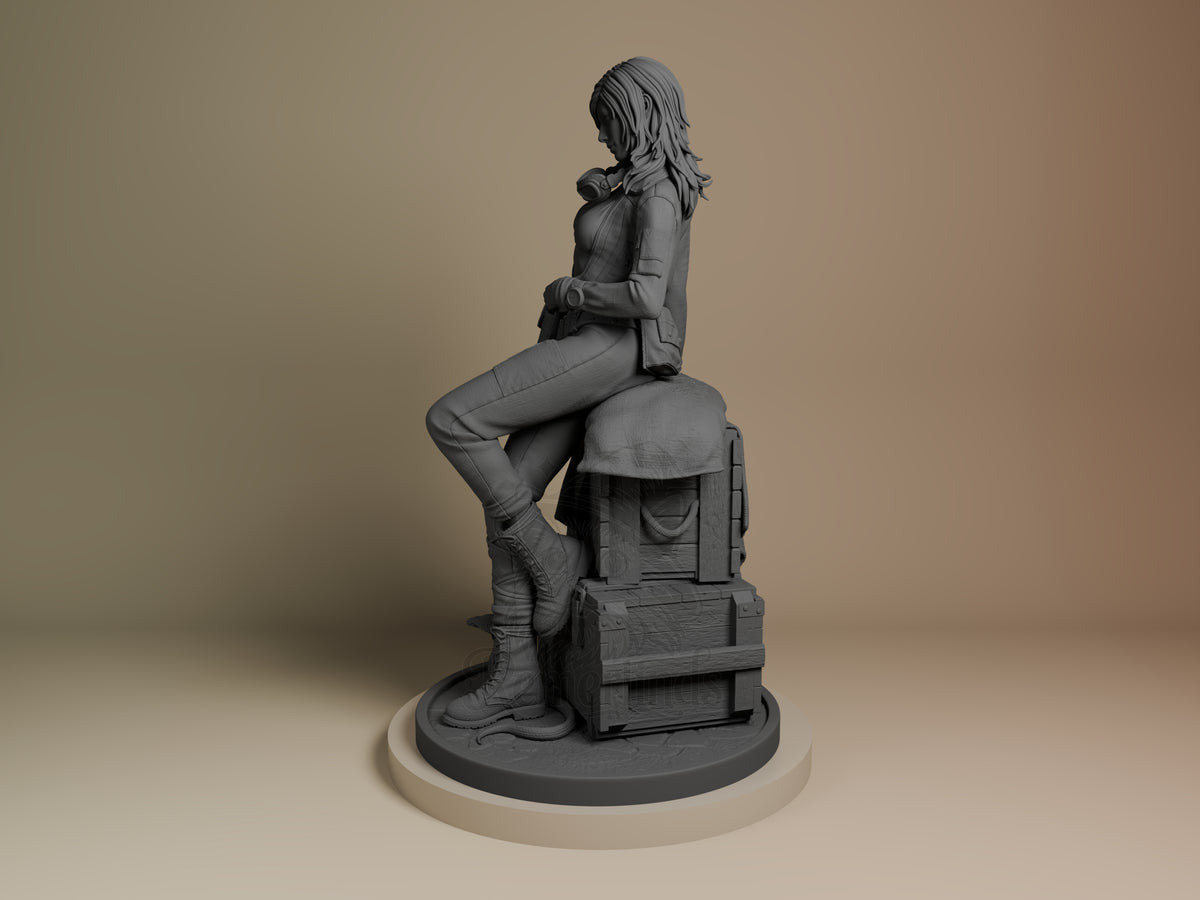 EVA from Metal Gear resin figure shown at angle, seated pose on wooden crate base, unpainted gray resin, detailed clothing and boots.