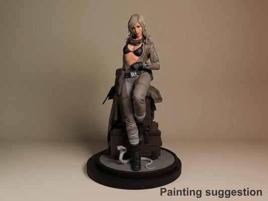 EVA from Metal Gear Solid resin figure, seated pose on brown base, painted in tan and black outfit with weapons, front three-quarter view.