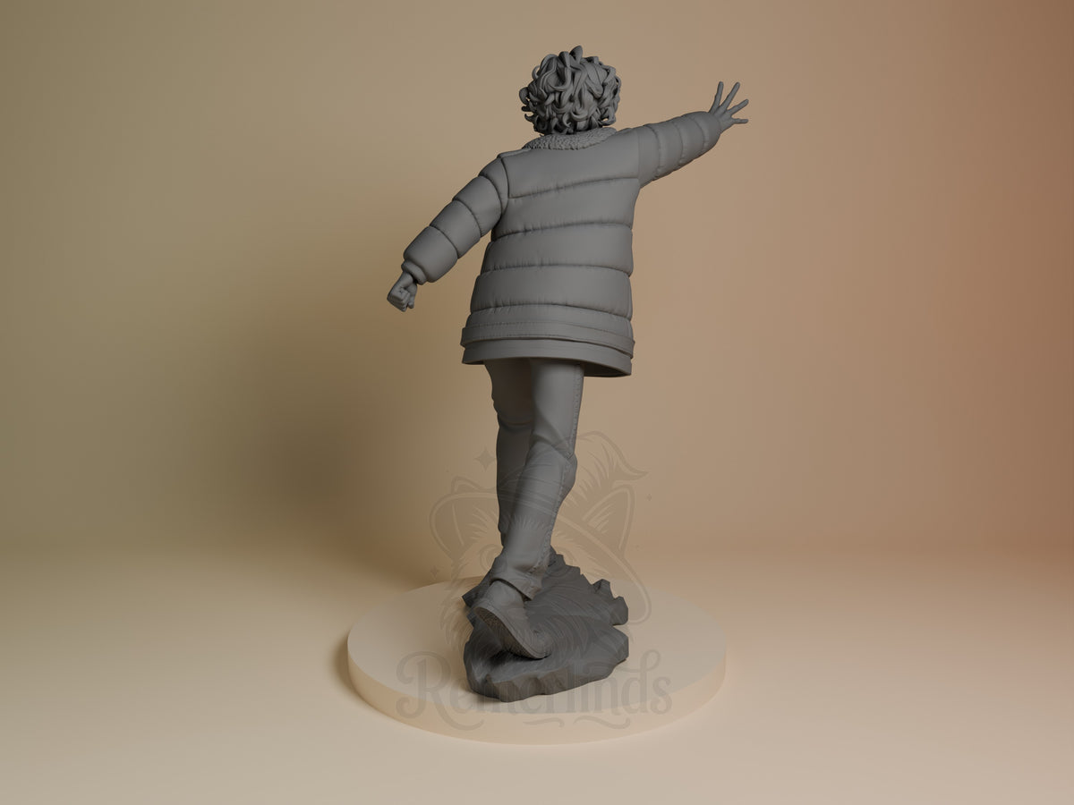 Back view of Eleven from Stranger Things, an unpainted resin figure reaching outward on a rocky base.