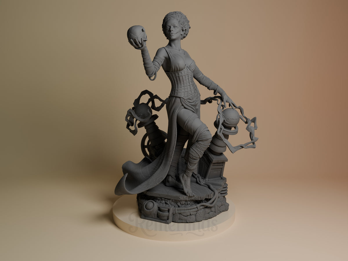 Frankenstein's Bride resin figure from front angle, holding a skull aloft with flowing cape, flanked by two smaller figures on decorative base, unpainted gray finish.