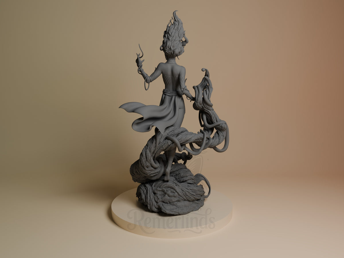 Gaia resin figure shown from left angle, featuring a robed character with elaborate hair atop mythical creatures, holding a staff, unpainted gray finish on cream base.