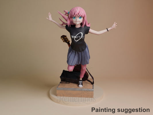 Hitori Gotoh resin figure in dynamic pose with arms outstretched, pink hair flowing, black graphic tee and purple skirt, painted details on wooden base.