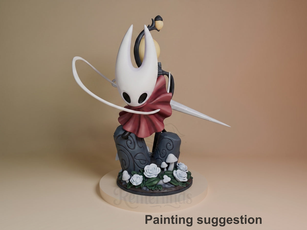 Hornet resin figure from Hollow Knight shown painted in white, black, and burgundy, posed mid-action on a decorative dark base with white flowers and mushrooms.