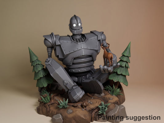 Iron Giant resin figure posed on rocky base with trees, holding weapon and small deer, metallic gray paint with white eyes, front three-quarter view.