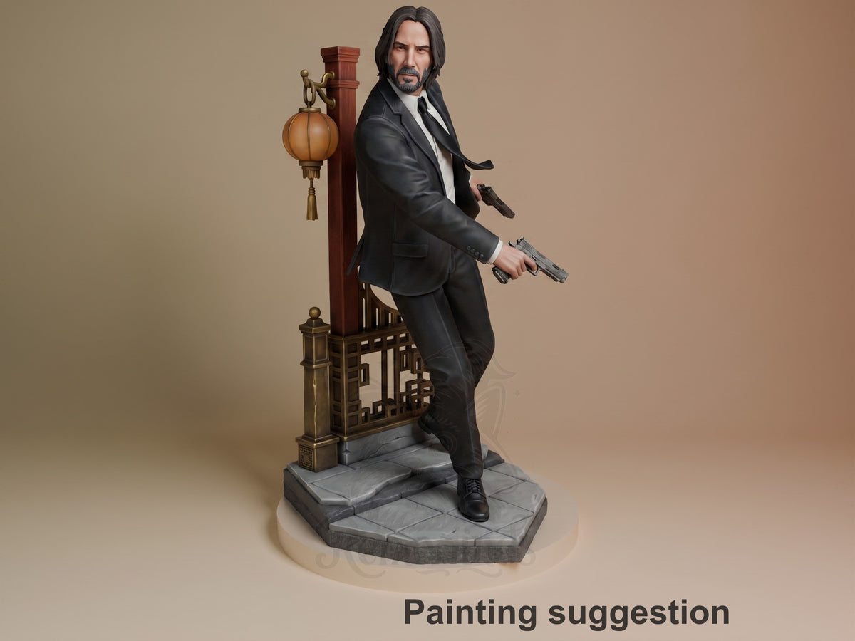 Three-quarter view shows a painted John Wick resin figure from John Wick with pistols on a sculpted base.