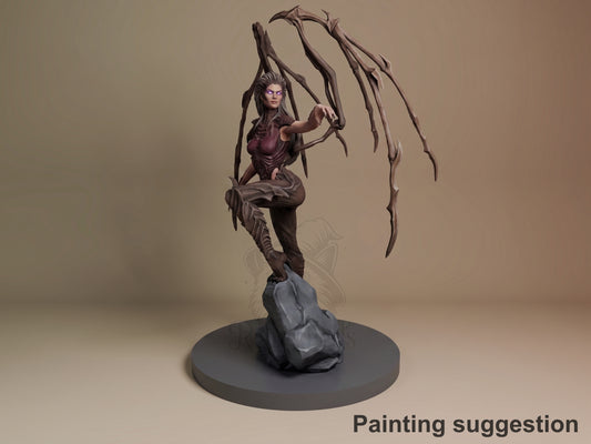 Kerrigan resin figure from StarCraft II in dynamic pose on rocky base, painted with purple skin tone and dark armor, organic tentacle-like appendages raised overhead.