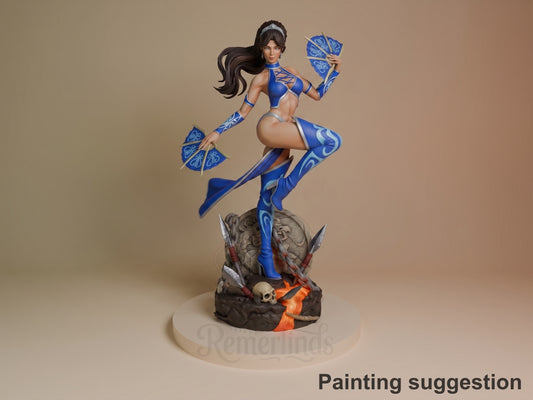 Kitana resin figure in blue combat outfit, posed dynamically on rocky base with flame effects, holding fan weapons, fully painted with detailed base.