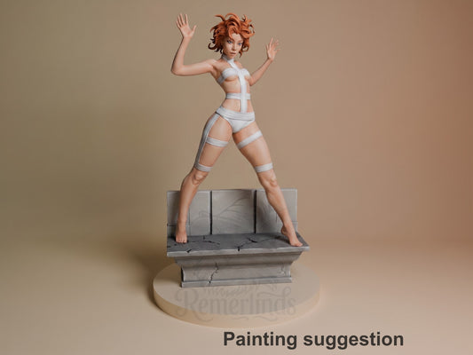 Painted Leeloo from The Fifth Element resin figure stands wide-legged with raised arms on a cracked sculpted pedestal.