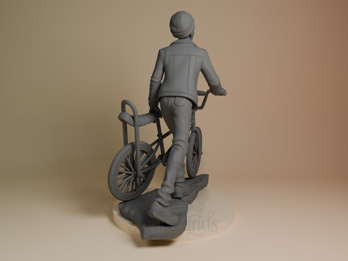 Back three-quarter view of Lucas from Stranger Things, an unpainted resin figure on a bicycle and sculpted base.