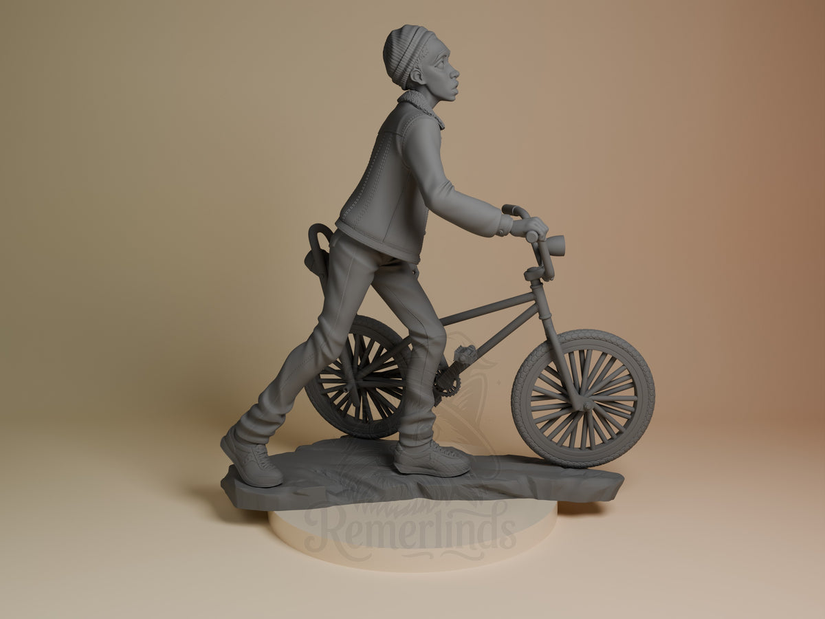 Lucas from Stranger Things is an unpainted resin figure, posed beside a bicycle on a sculpted base.