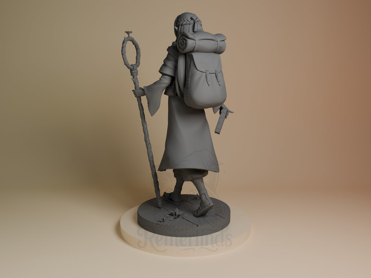 Marcille resin figure from Delicious in Dungeon, unpainted gray, shown from left angle holding staff and axe, wearing backpack and cloak on textured base.