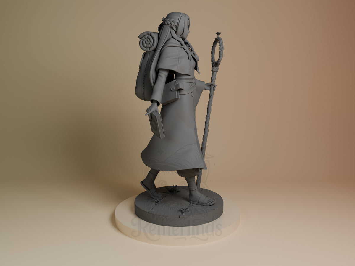 Marcille from Delicious in Dungeon resin figure shown from the right side, holding a staff, with backpack and accessories, unpainted gray finish on round base.