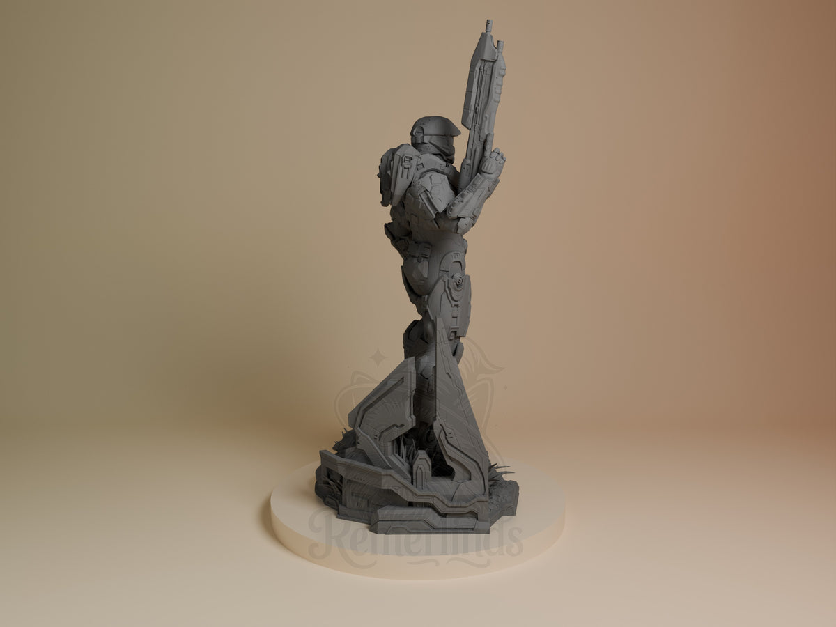 Master Chief resin figure from Halo, unpainted gray, shown from back view holding rifle aloft, mounted on futuristic base.