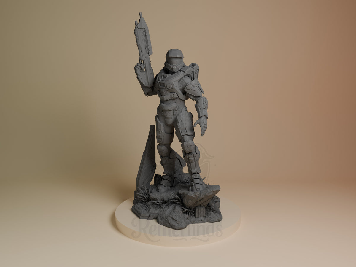 Master Chief resin figure from Halo standing heroically with rifle raised, unpainted gray finish on rocky base, front three-quarter view.