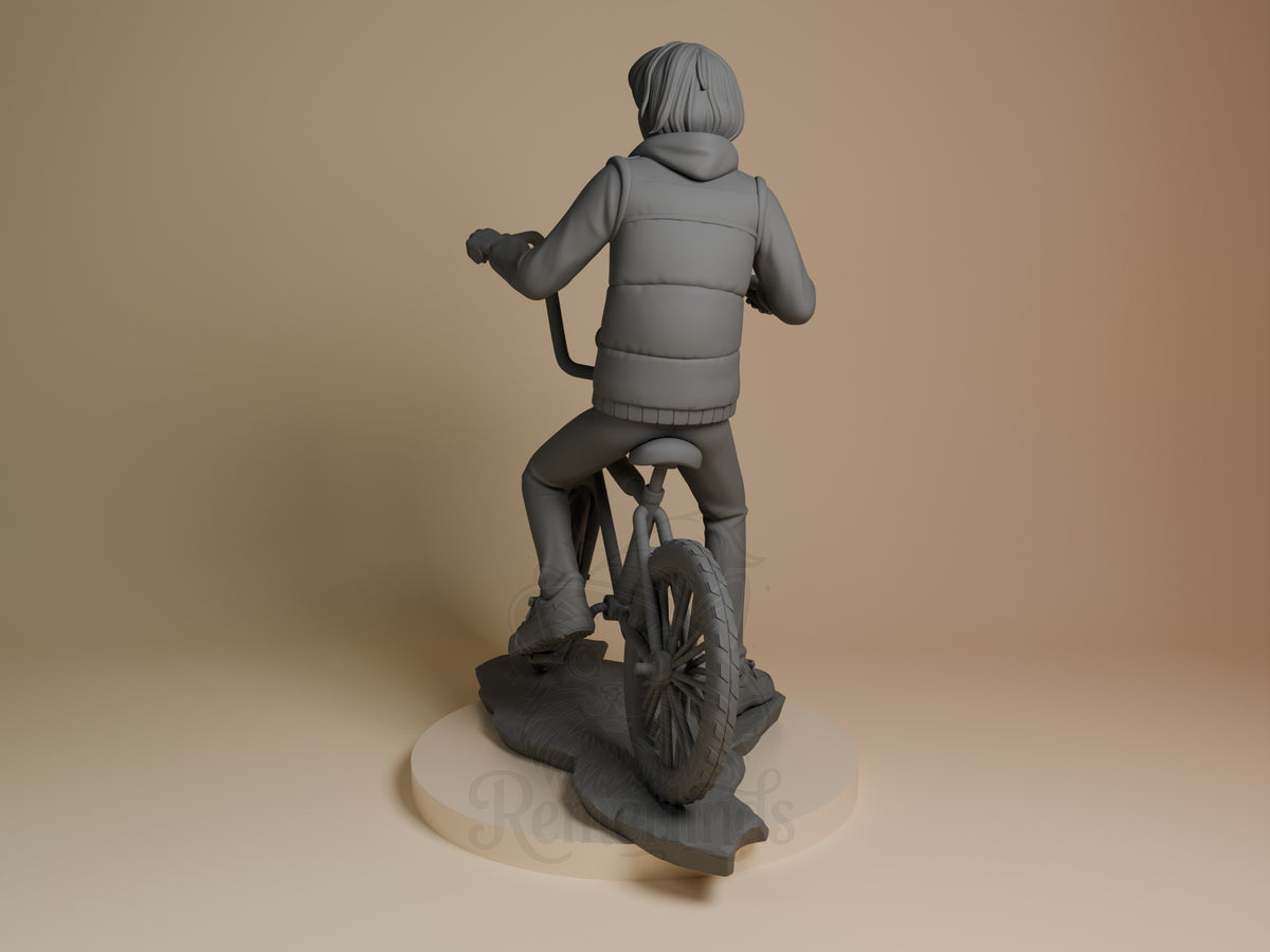 Mike from Stranger Things is rear-facing as an unpainted resin figure on sculpted bicycle base.