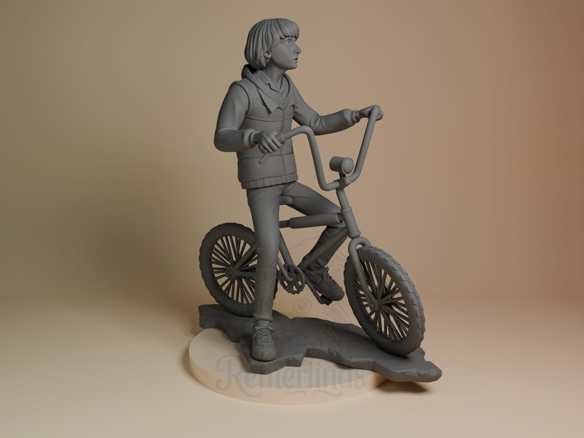 Mike from Stranger Things appears in a right-facing pose as an unpainted resin figure riding a bicycle on a sculpted base.