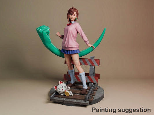 Momo Ayase resin figure from Dandadan in painted pink sweater and blue skirt, posed on wooden base with green tentacle prop and lucky cat figurine.