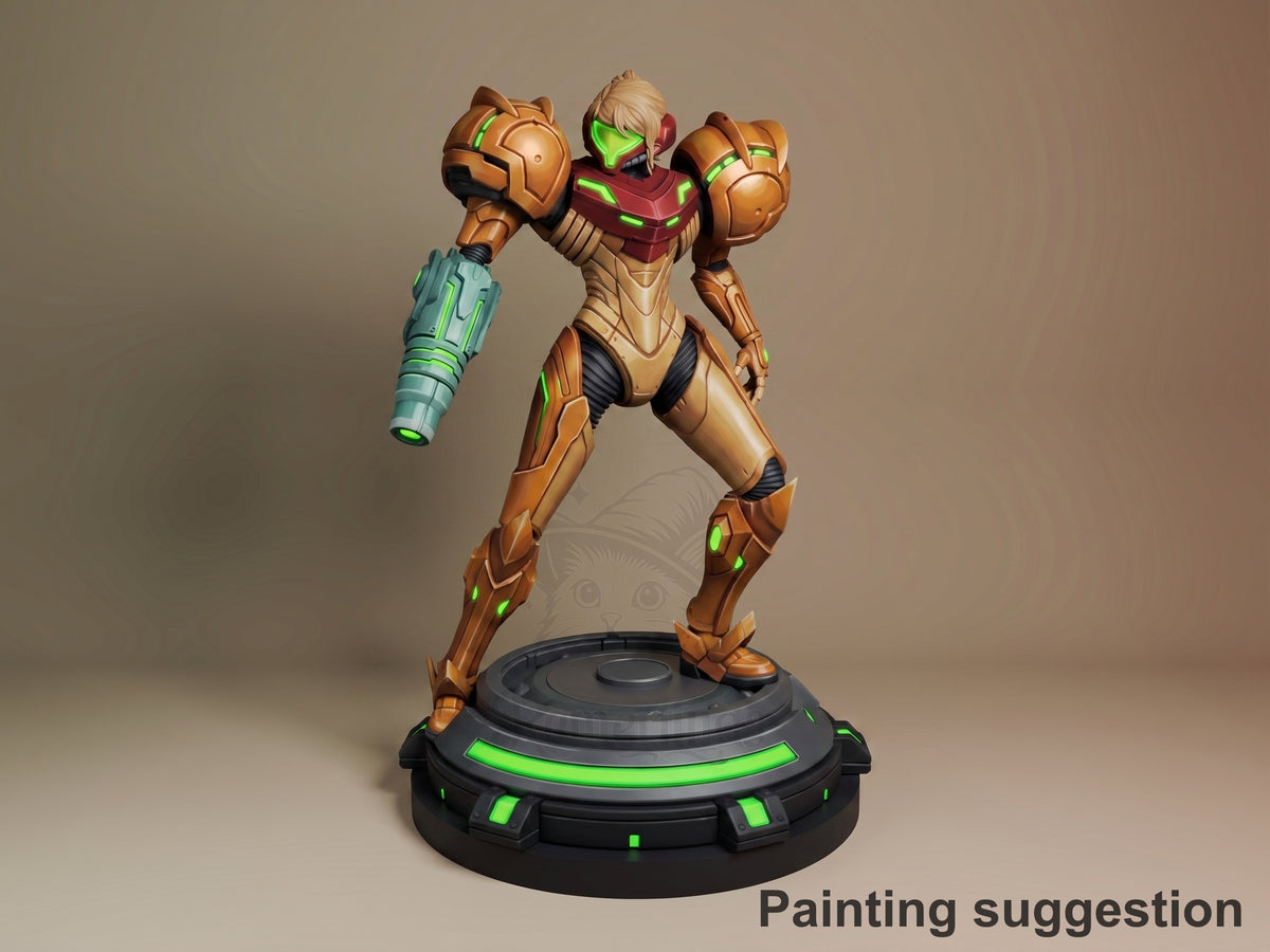 Power Suit Huntress resin figure in dynamic pose with raised weapon arm, gold and burgundy armor, green accents, on illuminated base.