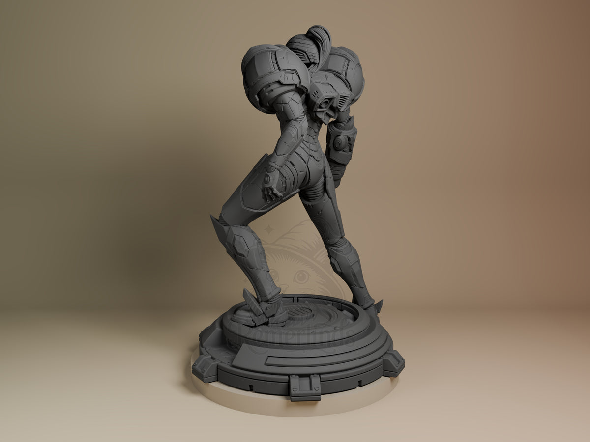Power Suit Huntress resin figure in dynamic pose on circular base, shown from left angle, unpainted gray finish with detailed armor plating and mechanical details.