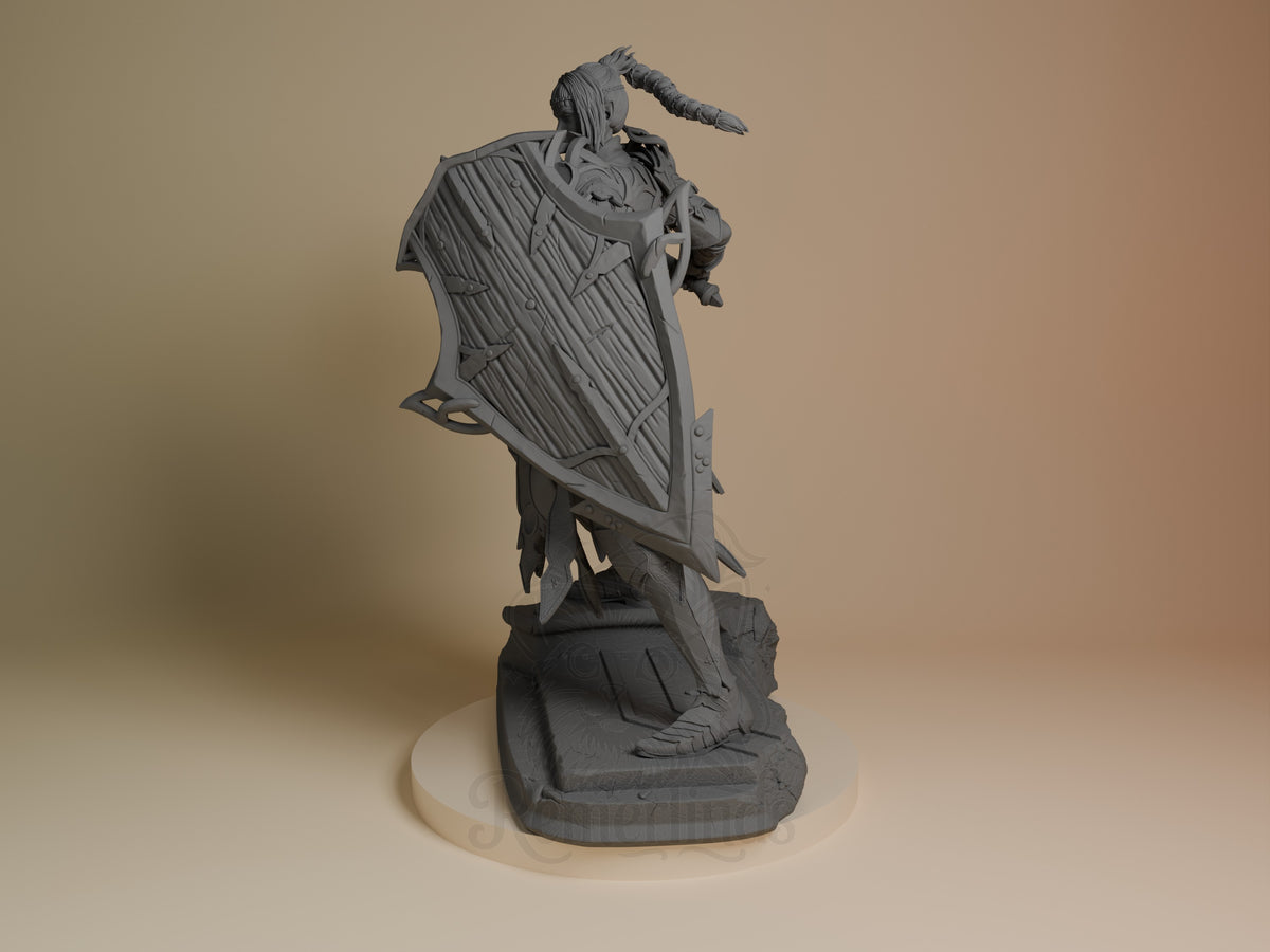 Shadowheart resin figure from Baldur's Gate shown at an angle, displaying her flowing cloak and pointing pose on a dark base, unpainted gray resin.