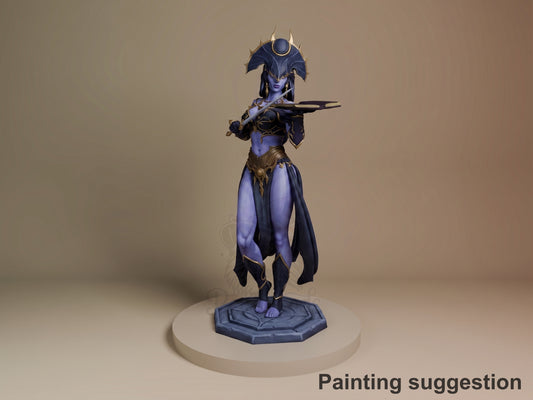Shar resin figure from Baldur's Gate standing on octagonal base, painted in blues and golds, holding staff with arm extended, detailed armor and spiky headdress visible.