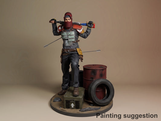 Painted resin figure of Survivor from Rust, posed dynamically with tools, standing on base with barrel and tire, shown from front angle.